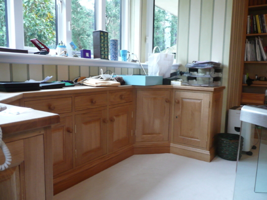 Oak cupboards behind desk