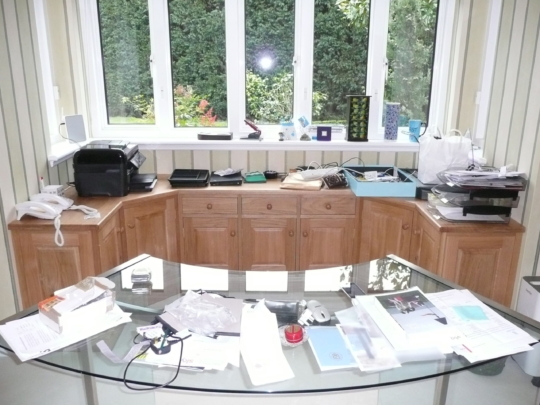 Oak cupboards behind desk