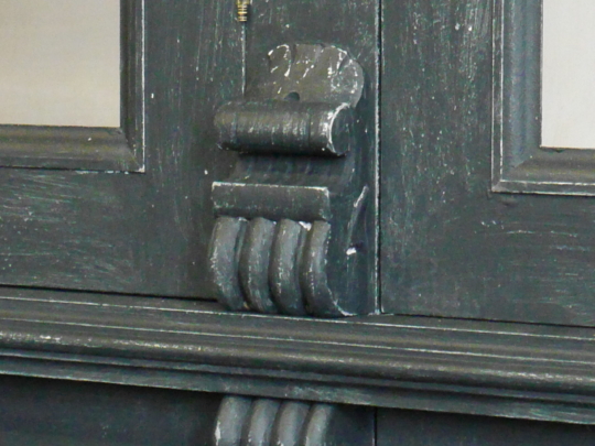 Distressed painted display cabinet detail