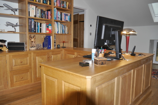 Oak panelled workstation and display shelves. New barn conversion installation